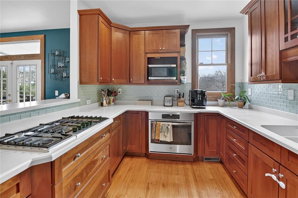 198 Dewey Street Pittsburgh, PA 15218 - Photo 18 of 45 a kitchen with stainless steel appliances sink stove and cabinets