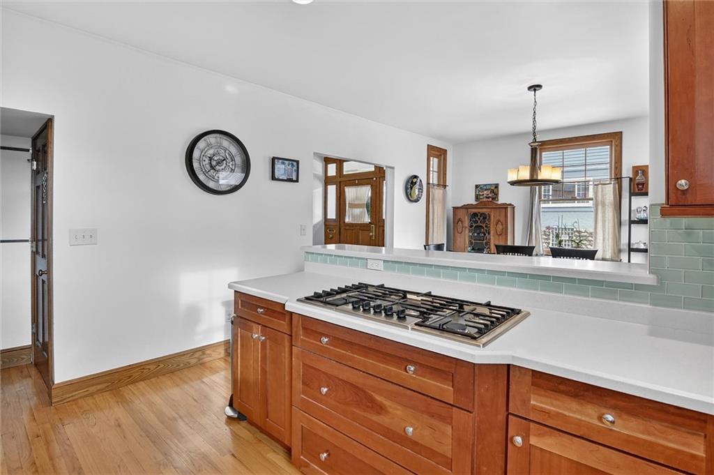 198 Dewey Street Pittsburgh, PA 15218 - Photo 19 of 45 a kitchen with a stove and a wooden floor