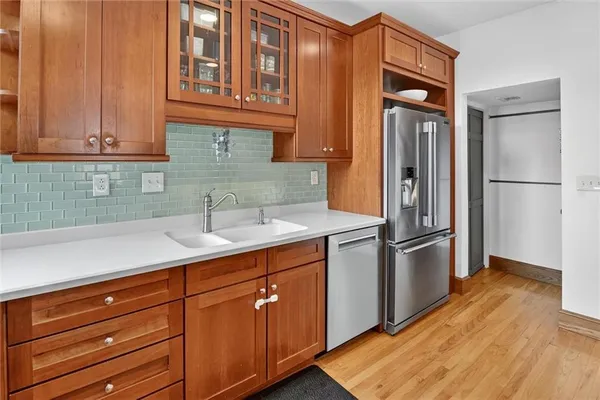 a kitchen with stainless steel appliances granite countertop a refrigerator and a sink