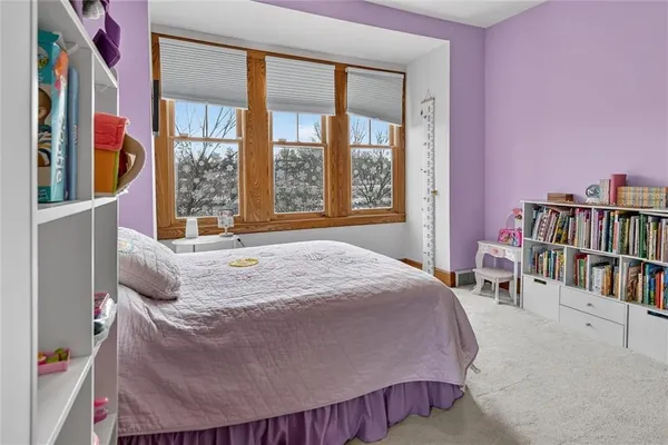 a bedroom with a bed and a book shelf