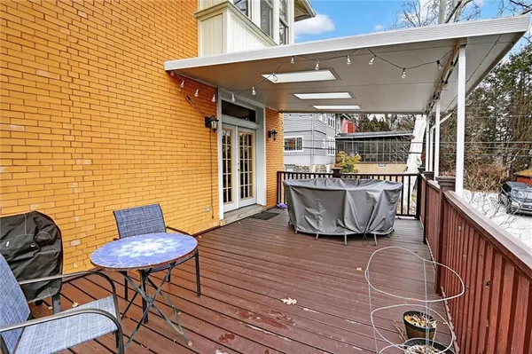 a roof deck with table and chairs