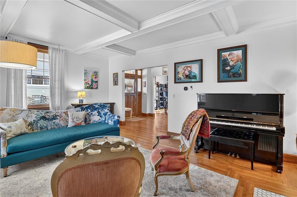 198 Dewey Street Pittsburgh, PA 15218 - Photo 9 of 45 a living room with furniture a flat screen tv and a floor to ceiling window