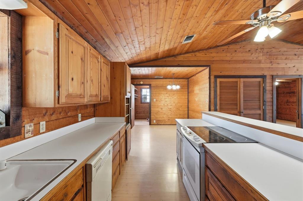 504 Windsor Lane Springtown, TX 76082 - Photo 14 of 40 a kitchen with a sink and large cabinets