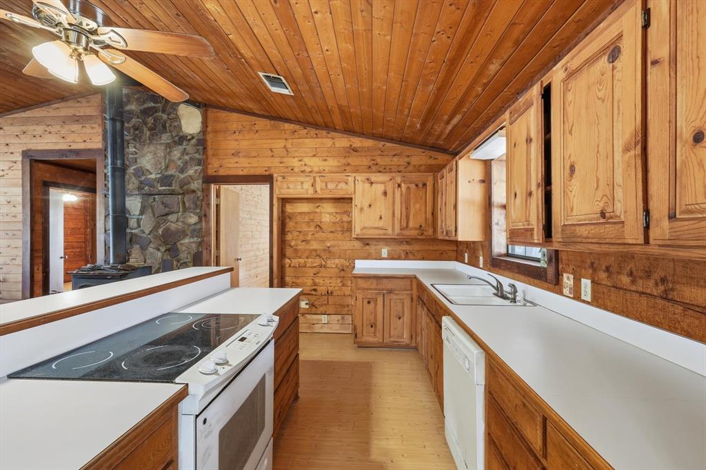 504 Windsor Lane Springtown, TX 76082 - Photo 17 of 40 a kitchen with a stove a sink and a refrigerator