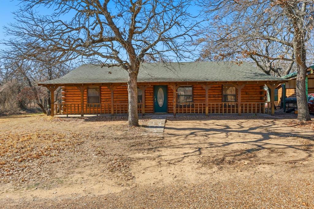 504 Windsor Lane Springtown, TX 76082 - Photo 2 of 40 front view of a house with a large tree