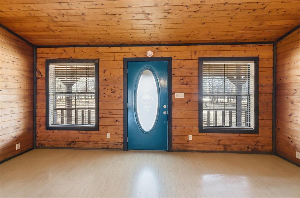504 Windsor Lane Springtown, TX 76082 - Photo 5 of 40 an empty room with a fireplace and windows