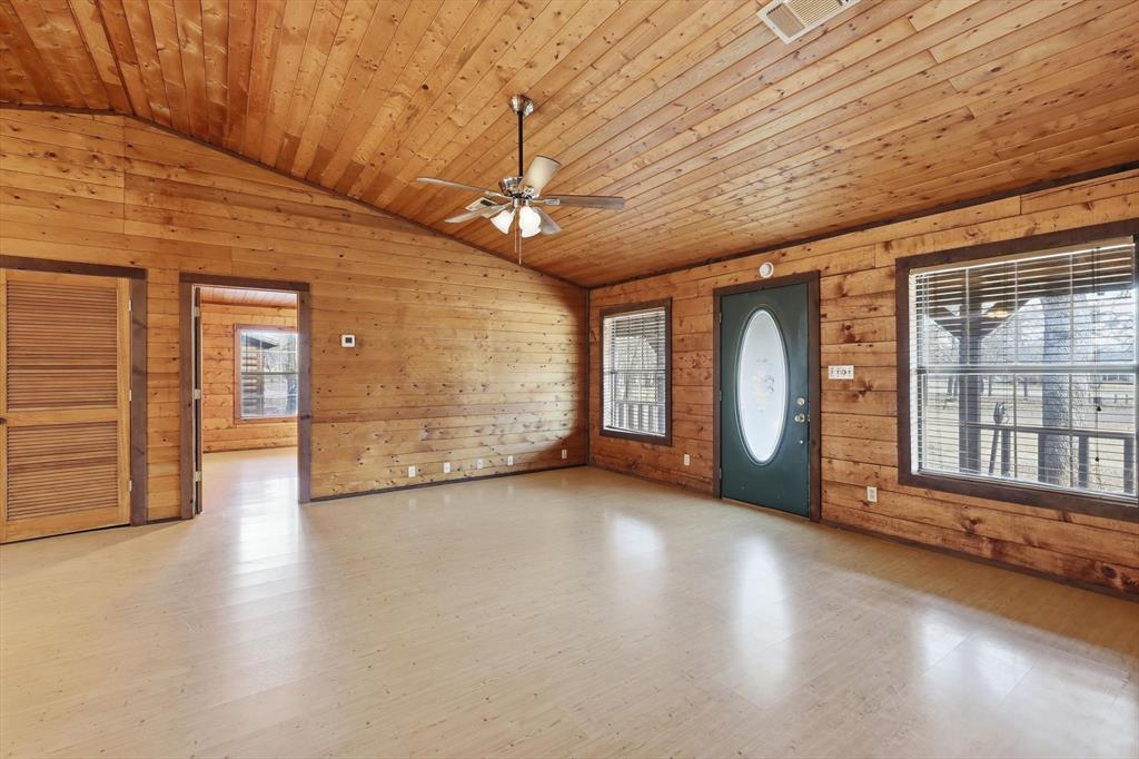 504 Windsor Lane Springtown, TX 76082 - Photo 6 of 40 a view of an empty room with a window and wooden floor