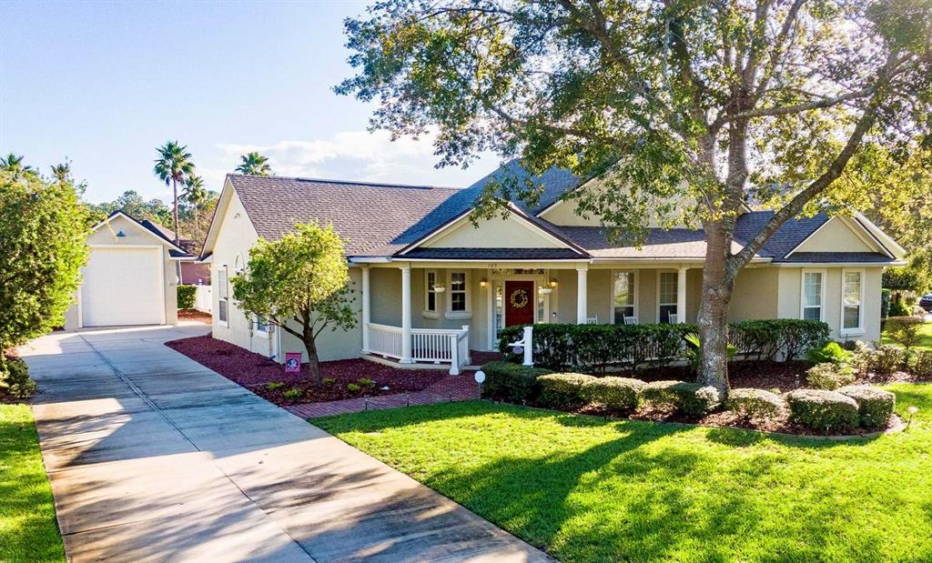 a front view of a house with garden and porch