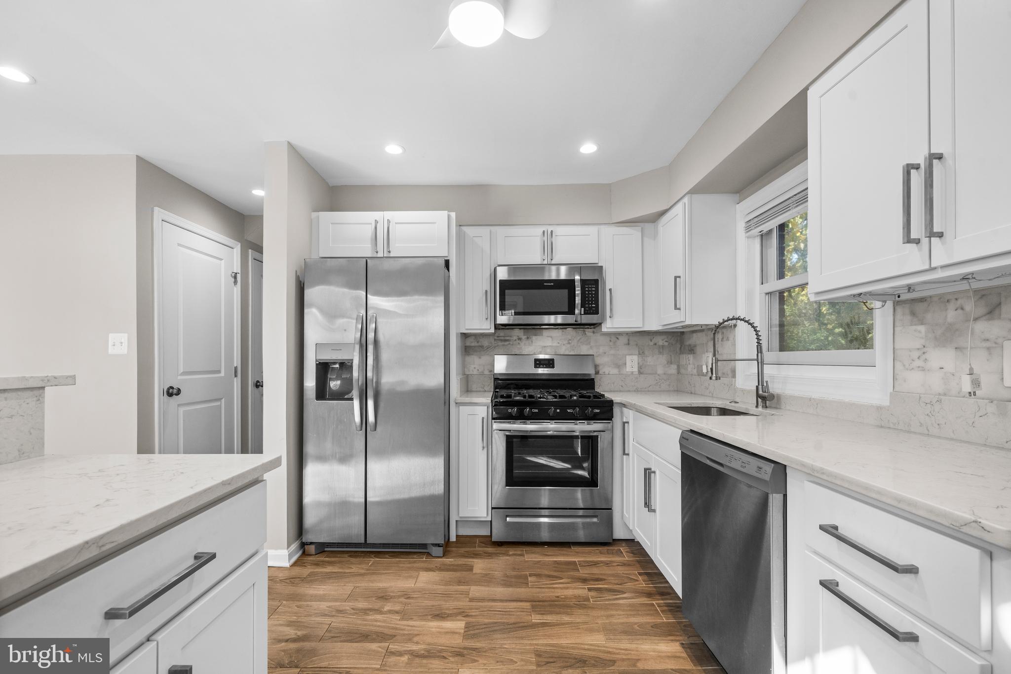 4314 Wheeler Road Southeast Washington, DC 20032 - Photo 11 of 36 a large kitchen with cabinets stainless steel appliances and a counter space