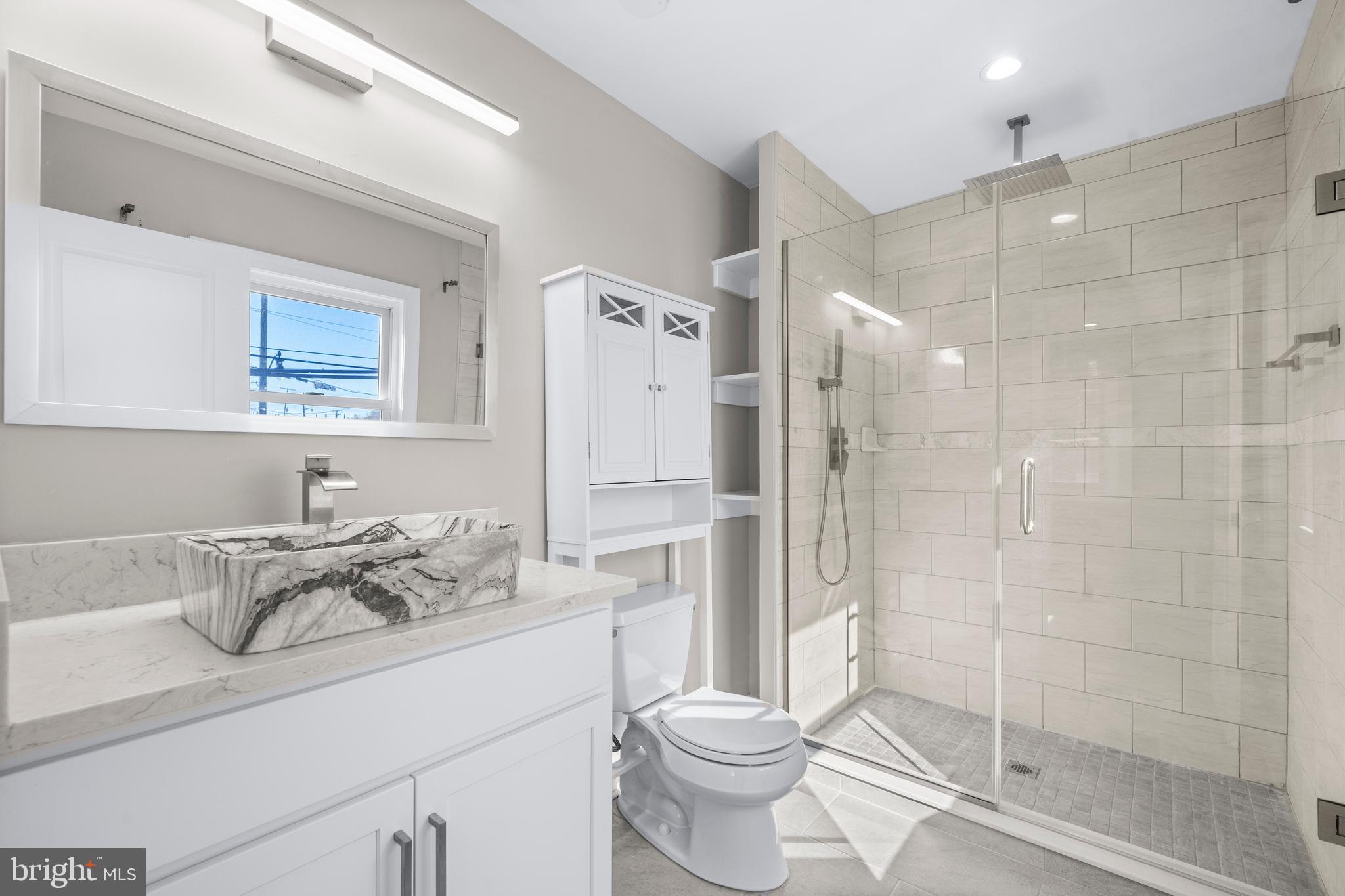 4314 Wheeler Road Southeast Washington, DC 20032 - Photo 17 of 36 a bathroom with a sink toilet and shower