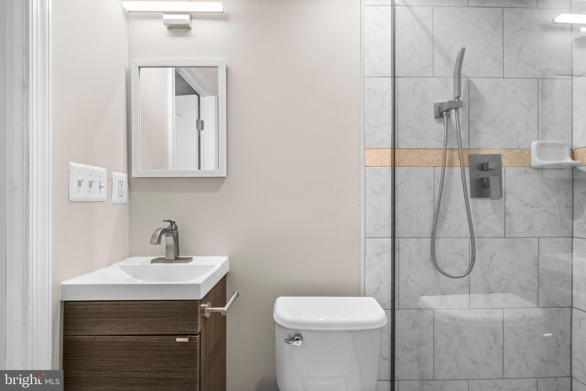 4314 Wheeler Road Southeast Washington, DC 20032 - Photo 27 of 36 a bathroom with a toilet sink and shower