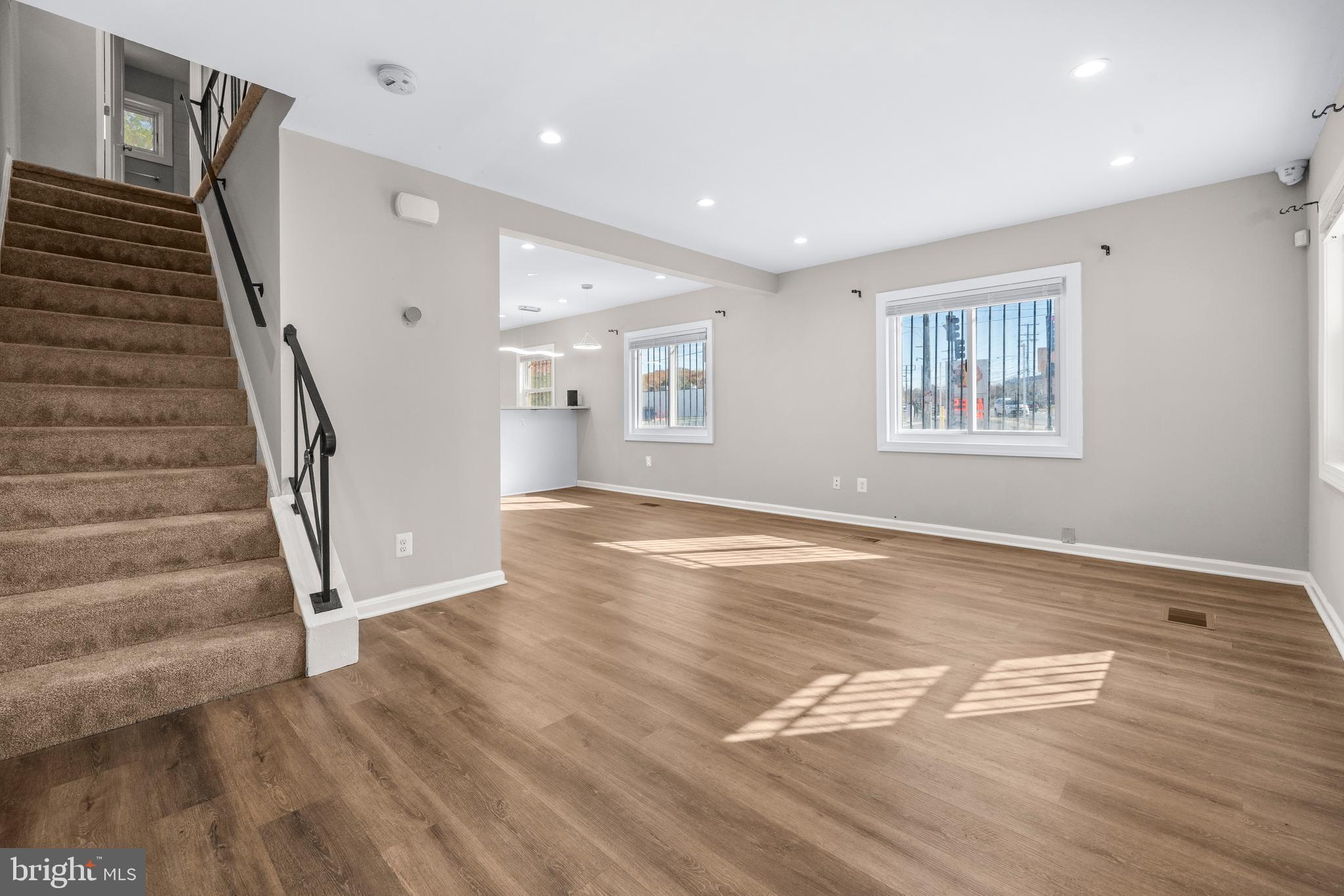 4314 Wheeler Road Southeast Washington, DC 20032 - Photo 3 of 36 a view of an empty room with wooden floor and stairs