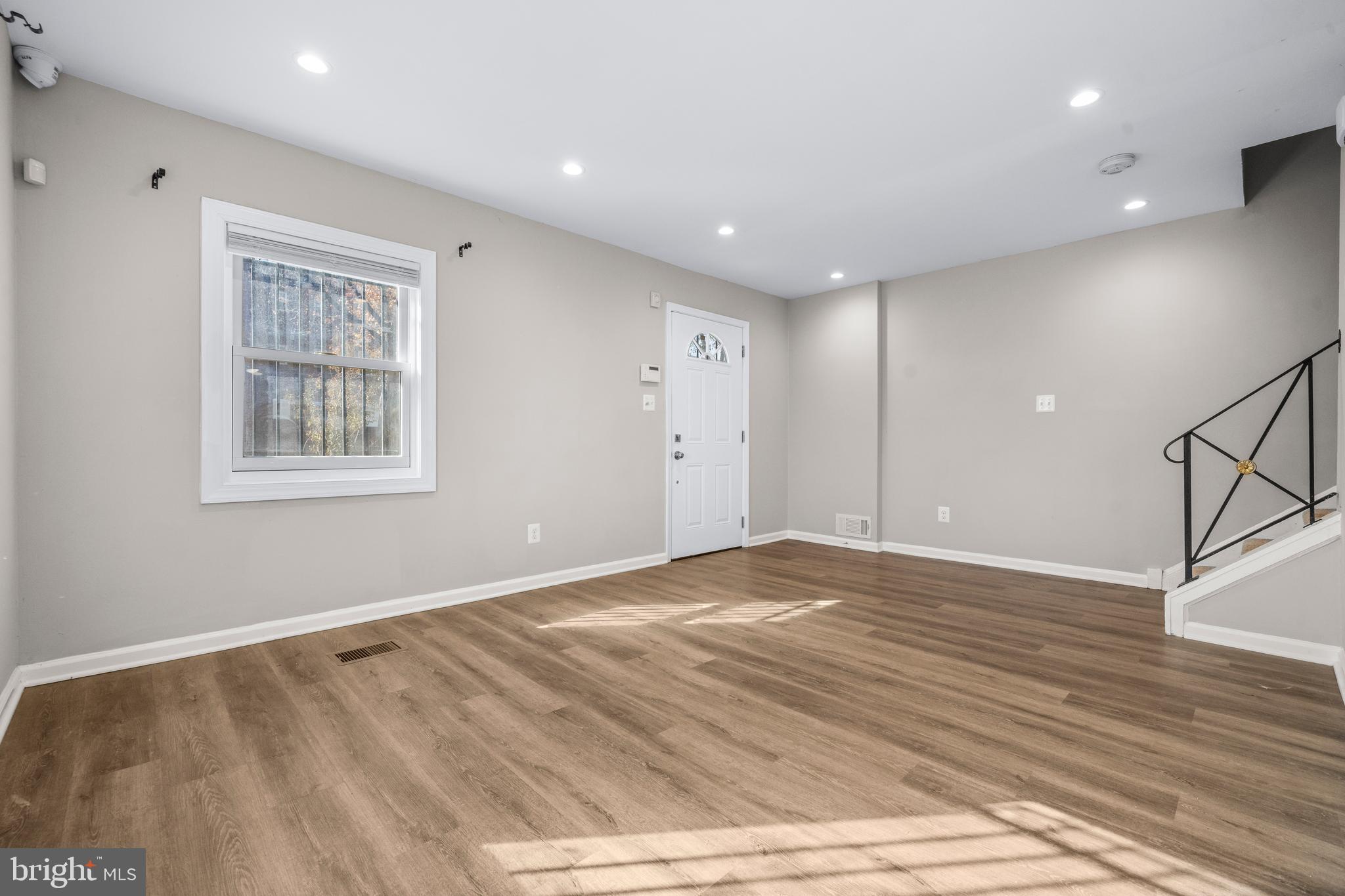 4314 Wheeler Road Southeast Washington, DC 20032 - Photo 6 of 36 a view of an empty room with wooden floor and a window