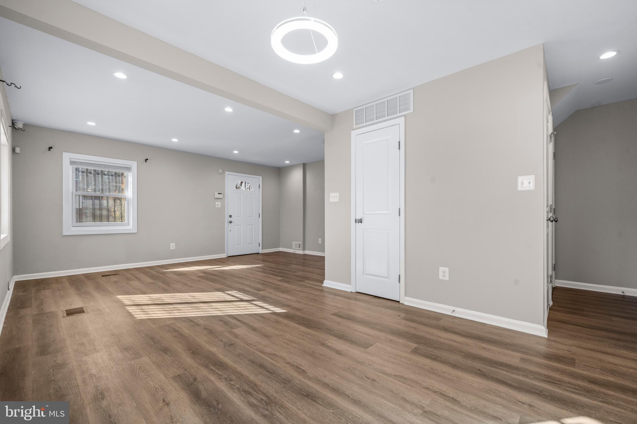 4314 Wheeler Road Southeast Washington, DC 20032 - Photo 8 of 36 an empty room with wooden floor and windows