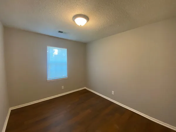 an empty room with a empty space and window