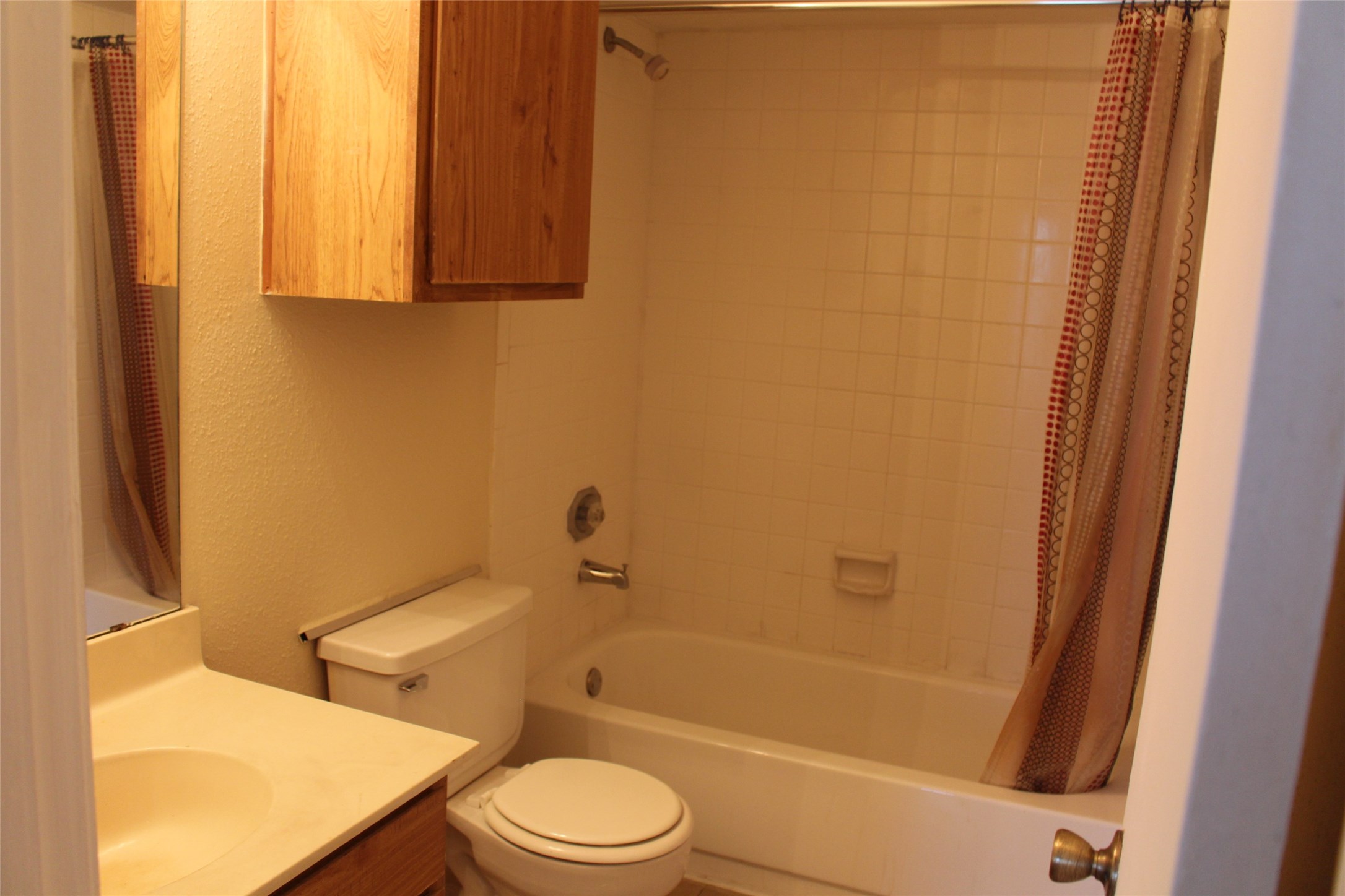 16111 Aspenglen Drive, Unit 806 Houston, TX 77084 - Photo 12 of 15 a bathroom with a toilet a sink and bathtub