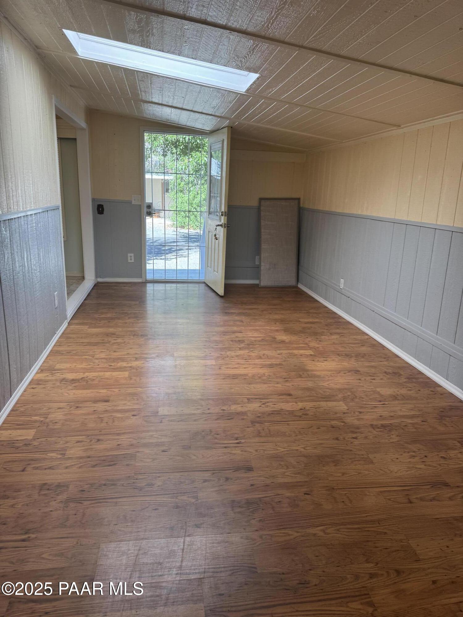 11250 East State Rte 69, Unit 80 Prescott Valley, AZ 86314 - Photo 4 of 13 a view of empty room with wooden floor and fan