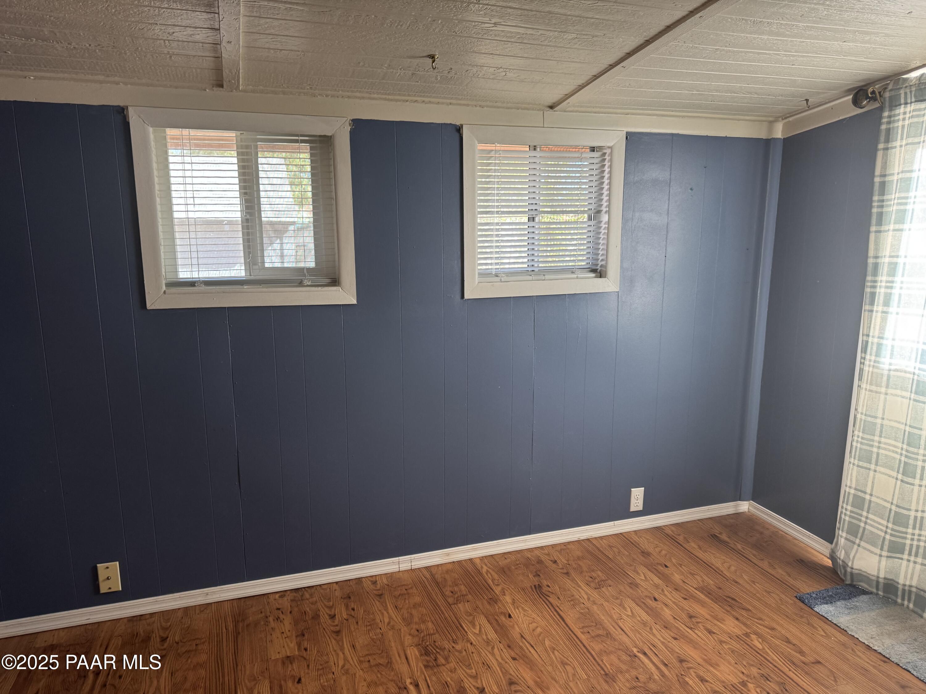 11250 East State Rte 69, Unit 80 Prescott Valley, AZ 86314 - Photo 10 of 13 a view of an empty room with wooden floor and a window