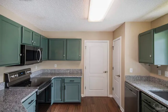 a kitchen with granite countertop a stove and a sink