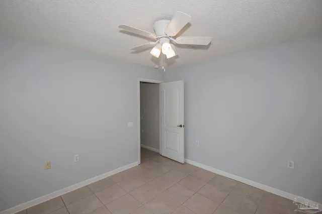 a view of an empty room with a fan