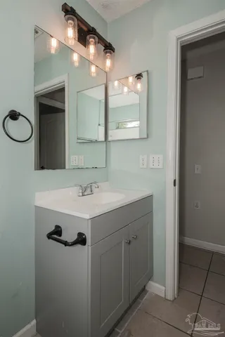 a bathroom with a sink vanity and a mirror