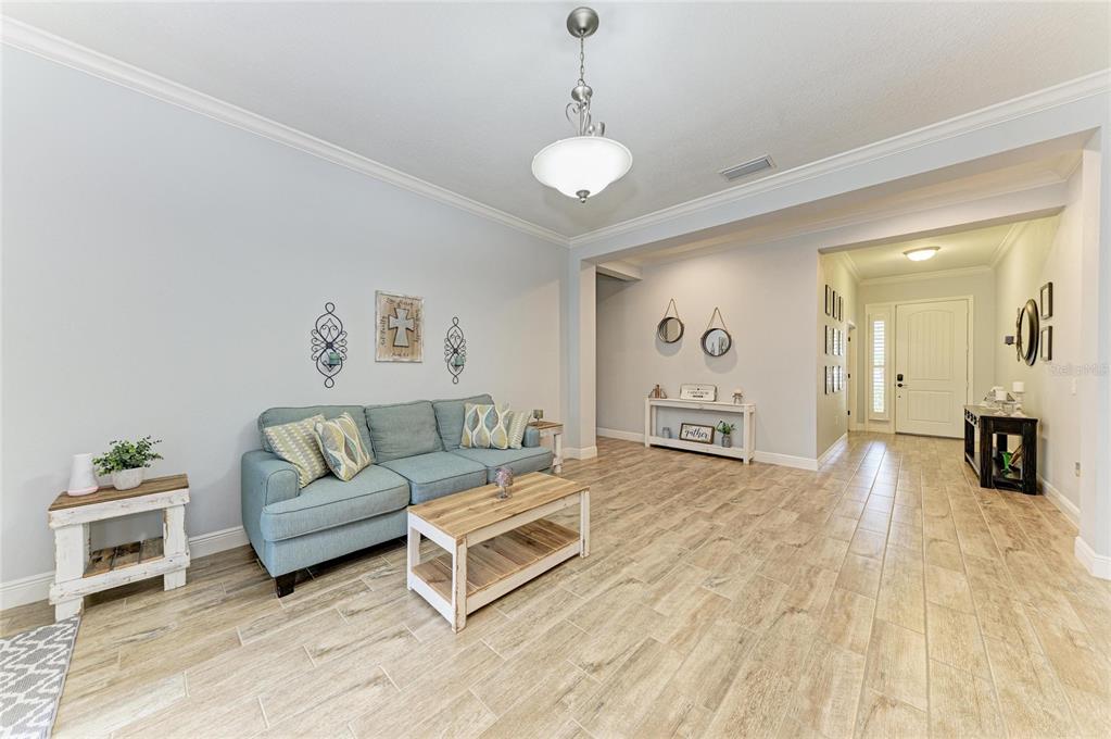 12642 Harney Street Venice, FL 34293 - Photo 11 of 85 a living room with furniture and wooden floor