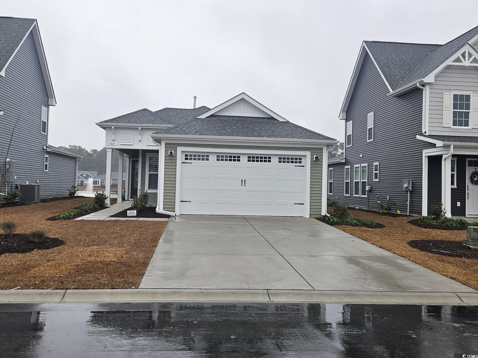 823 Cascade Loop Little River, SC 29566 - Photo 1 of 22 View of front of home with a garage and central AC