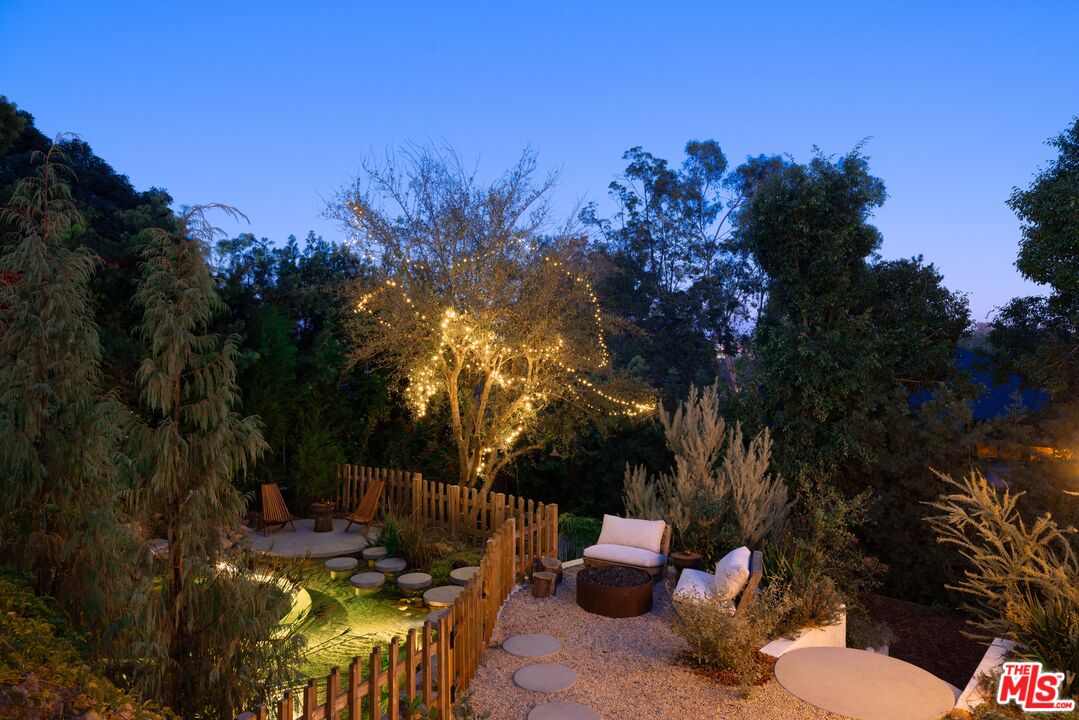 2226 Moreno Drive Los Angeles, CA 90039 - Photo 59 of 65 a view of a patio with couches table and chairs under an umbrella with large trees