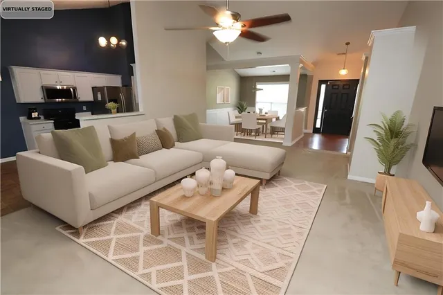 a living room with furniture and a chandelier
