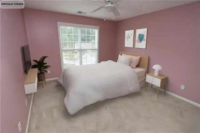a bedroom with a bed and a potted plant