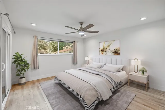 a bedroom with a large bed and a chandelier