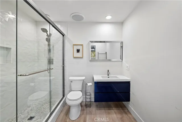 a bathroom with a toilet a sink and a mirror