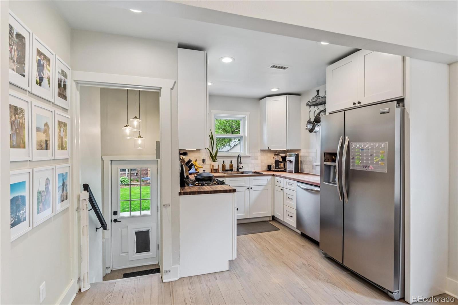 3612 Perry Street Denver, CO 80212 - Photo 12 of 50 a kitchen with cabinets and stainless steel appliances