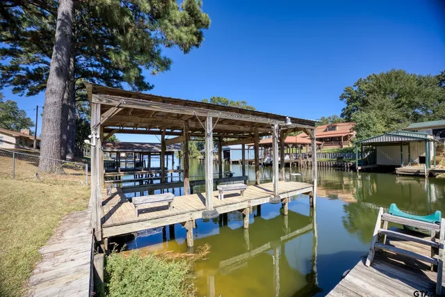 a view of a lake with couches chairs