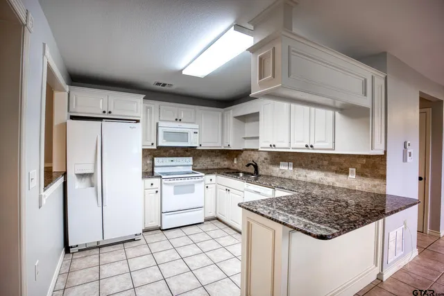 a kitchen with appliances cabinets and a counter top space