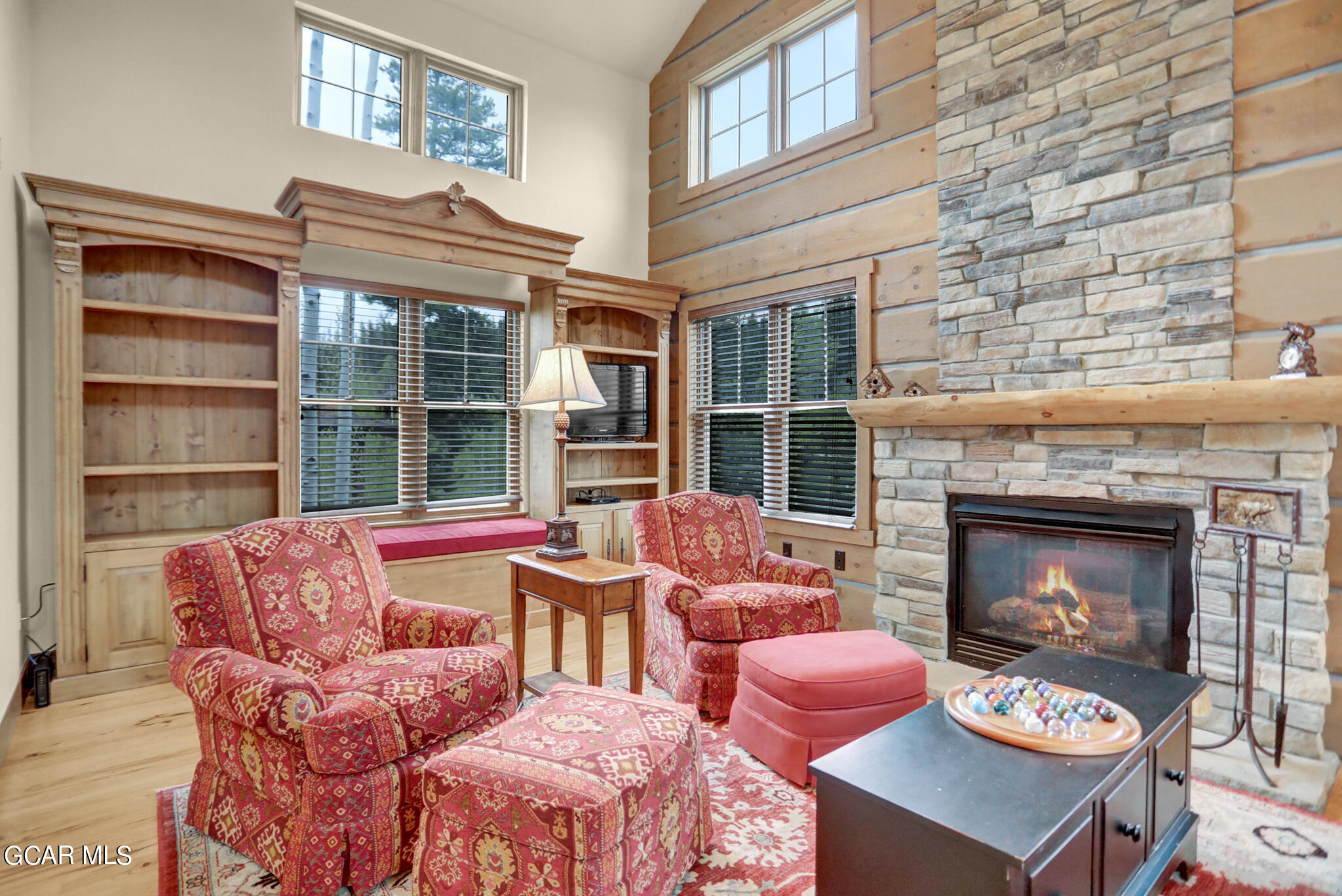 1180 Rendezvous Road Fraser, CO 80442 - Photo 15 of 44 a living room with furniture a fireplace and a large window