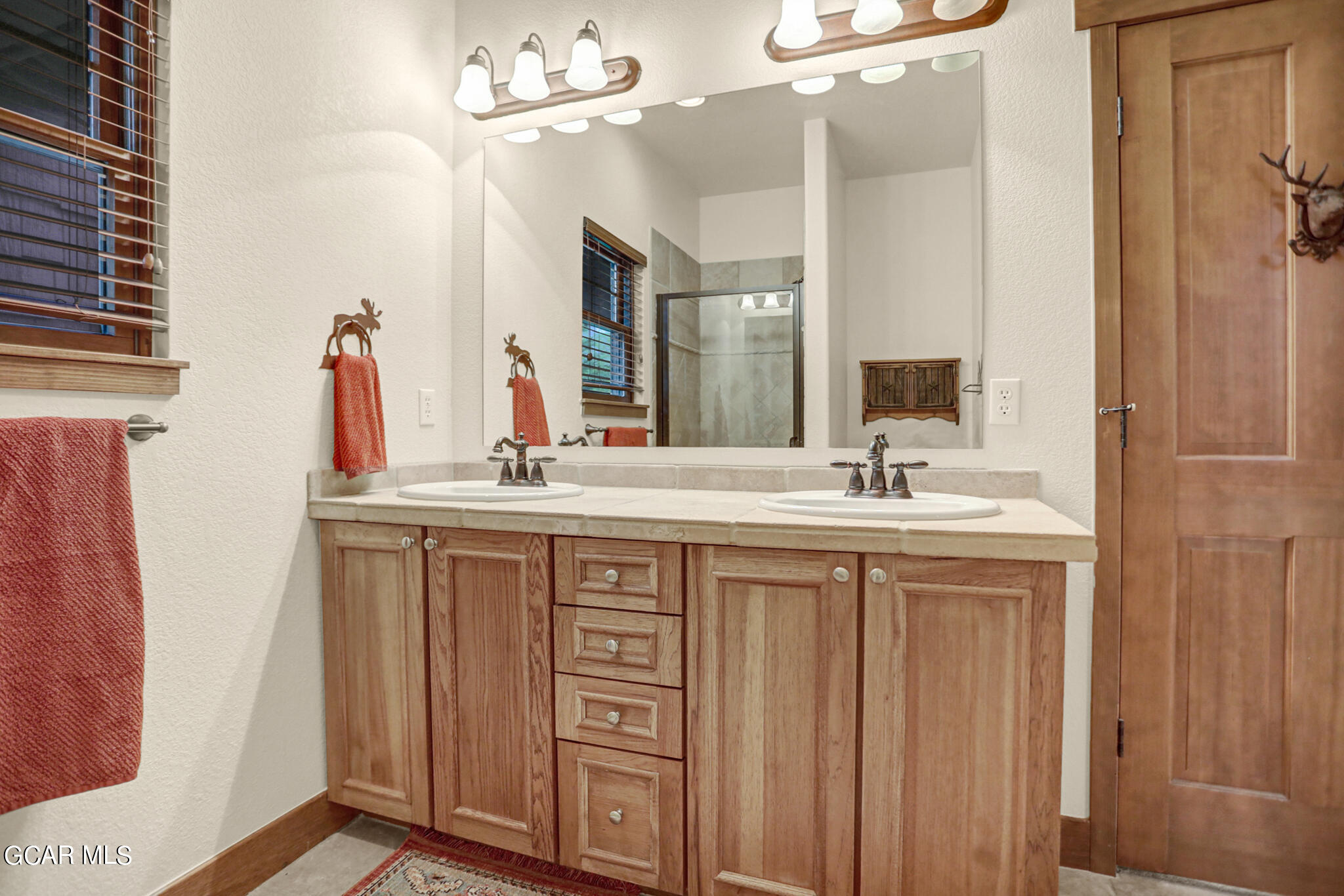1180 Rendezvous Road Fraser, CO 80442 - Photo 22 of 44 a bathroom with a double vanity sink and a mirror