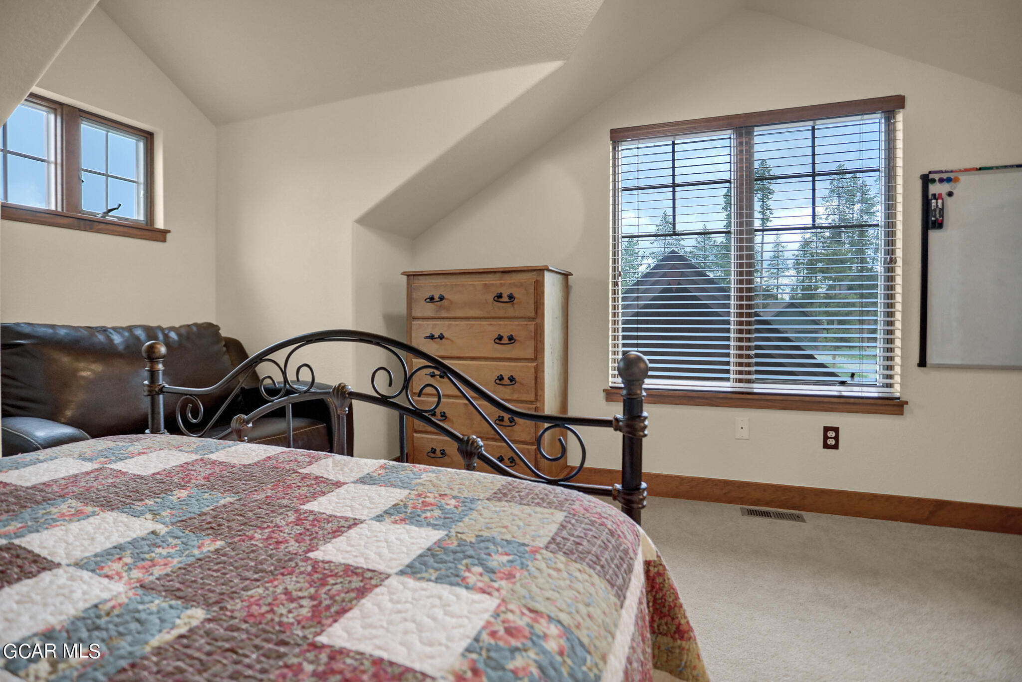 1180 Rendezvous Road Fraser, CO 80442 - Photo 35 of 44 a bedroom with a bed a table and a large mirror next to a window