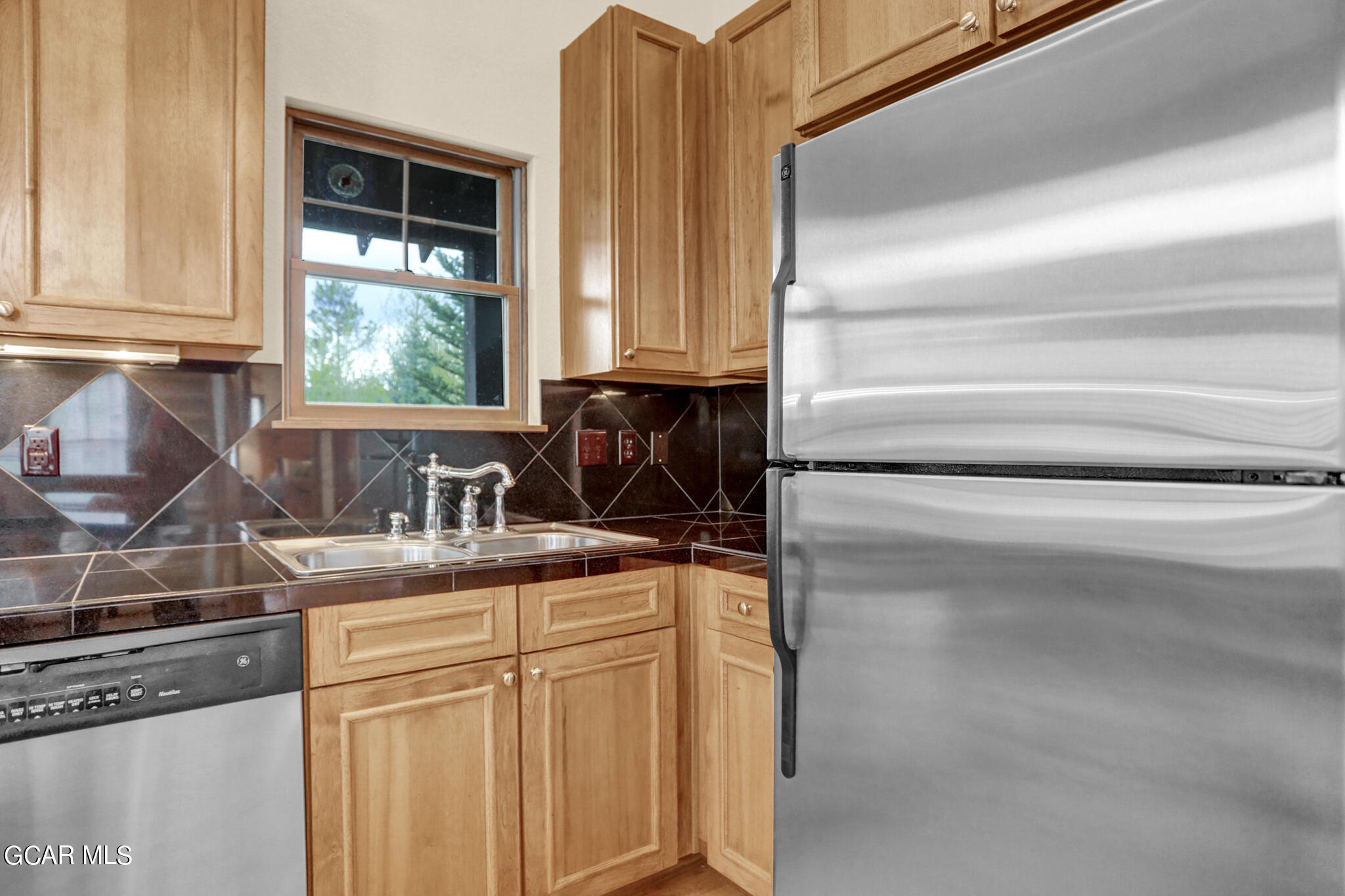 1180 Rendezvous Road Fraser, CO 80442 - Photo 6 of 44 a kitchen with granite countertop a sink and a stove top oven