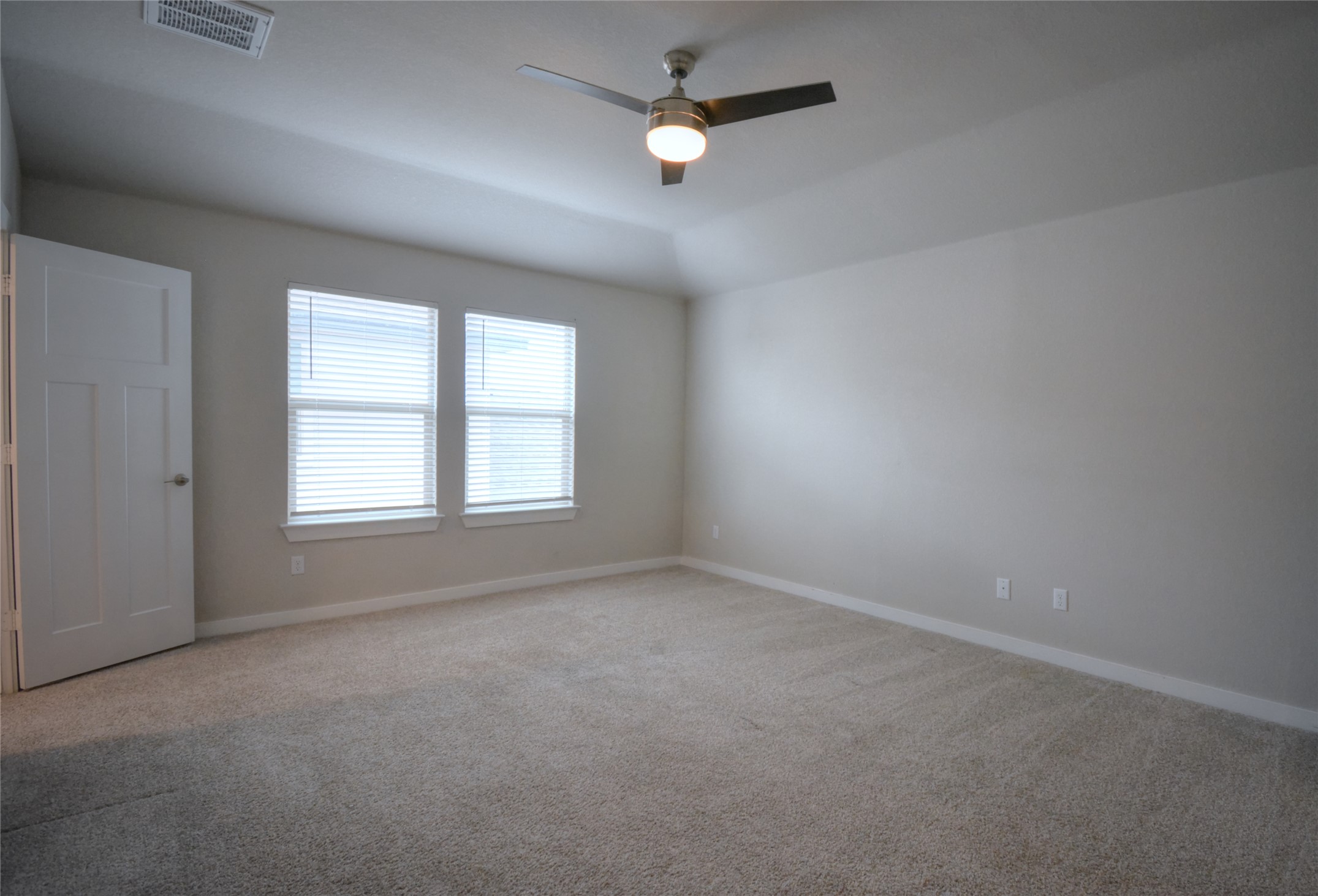 1137 Tipton Street Georgetown, TX 78633 - Photo 7 of 18 Unfurnished room with light colored carpet, ceiling fan, and vaulted ceiling