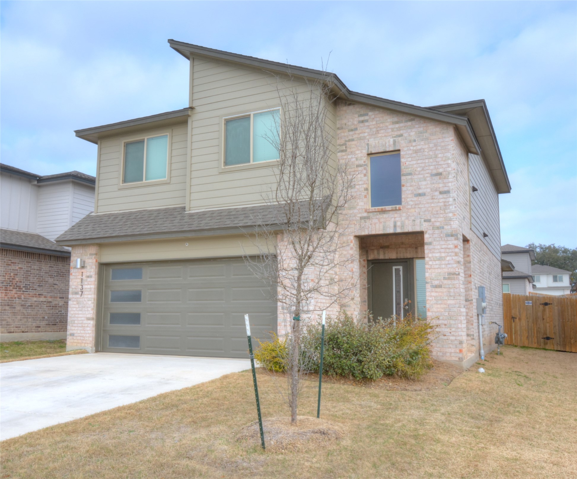 1137 Tipton Street Georgetown, TX 78633 - Photo 2 of 18 View of front of home featuring brick, siding, driveway, and a garage