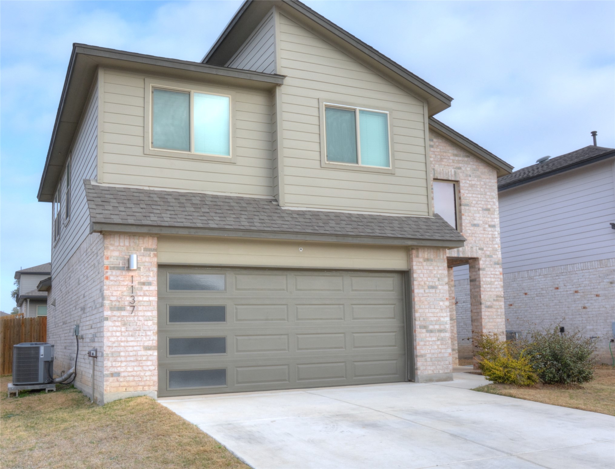 1137 Tipton Street Georgetown, TX 78633 - Photo 3 of 18 Traditional-style house featuring brick siding, a garage, driveway.