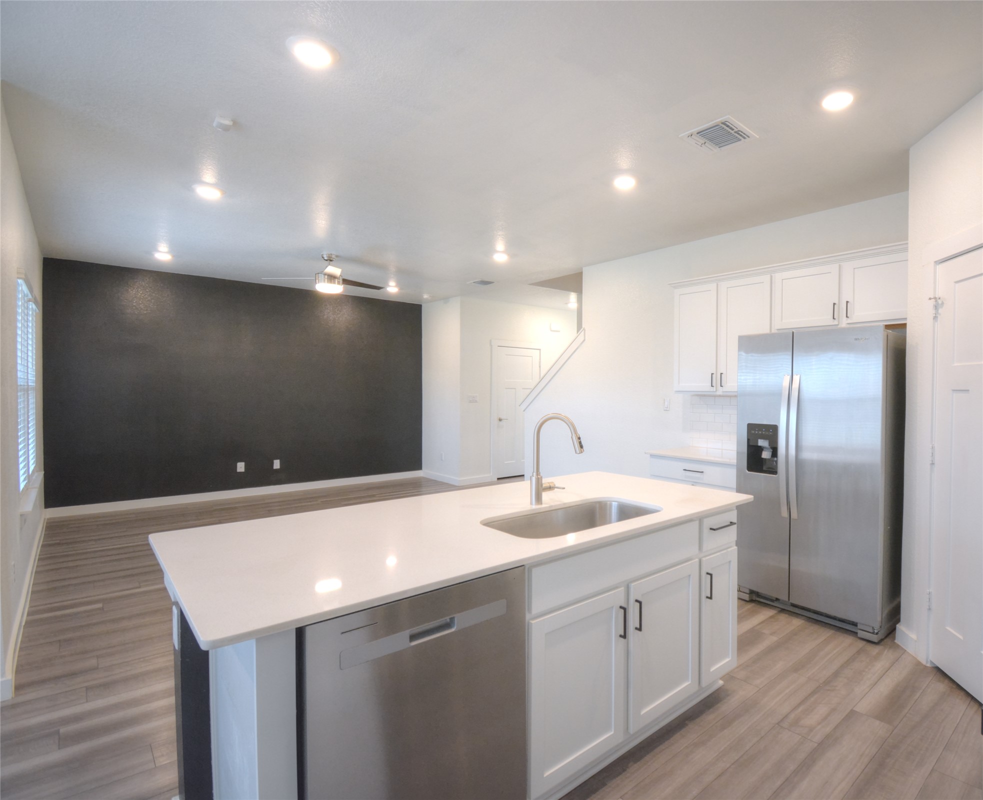 1137 Tipton Street Georgetown, TX 78633 - Photo 16 of 18 kitchen island with open floor plan, white cabinetry, recessed lighting, and light countertops
