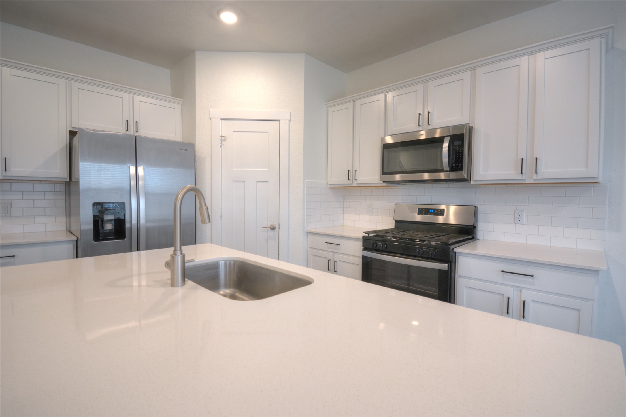 1137 Tipton Street Georgetown, TX 78633 - Photo 18 of 18 kitchen island with open floor plan, white cabinetry, recessed lighting, and light countertops