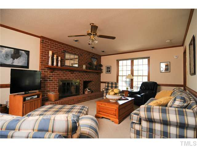 4018 Swarthmore Road Durham, NC 27707 - Photo 3 of 21 The family room offers a charming fireplace with brick hearth. Den/Family/Great Room