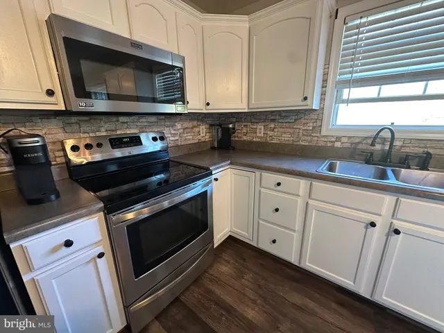 a kitchen with stainless steel appliances a stove a microwave and a refrigerator