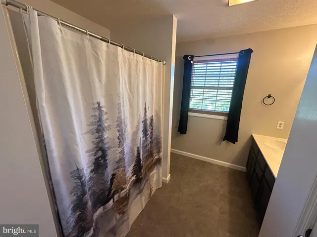 a view of a hallway with wooden floor and stairs