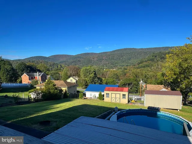 a view of balcony with wooden floor & fence