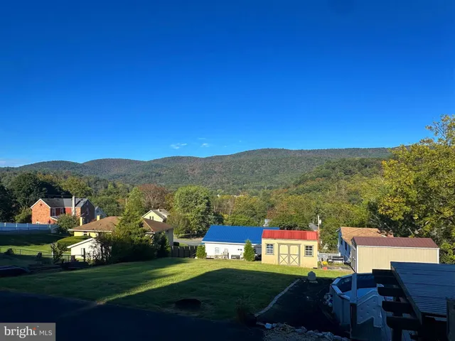 a view of house with yard and entertaining space