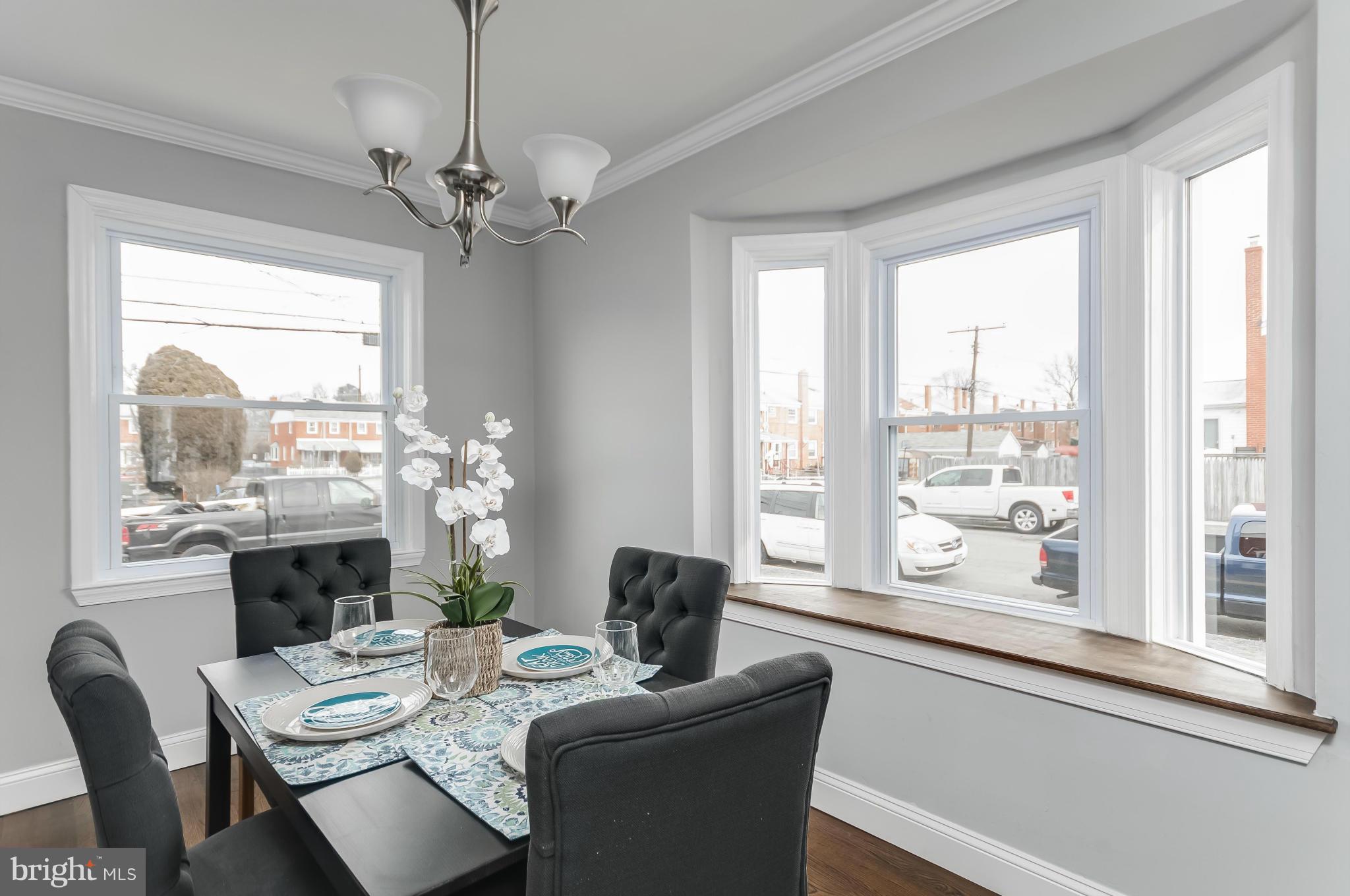 850 Arncliffe Road Baltimore, MD 21221 - Photo 3 of 24 a dining room with furniture a chandelier and window